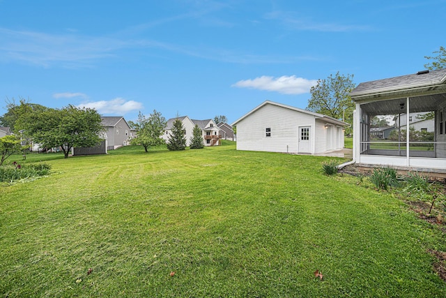7432 Burlingame Ave SW, Byron Center, MI 49315 - view of grassy yard with a sunroom and an outdoor structure