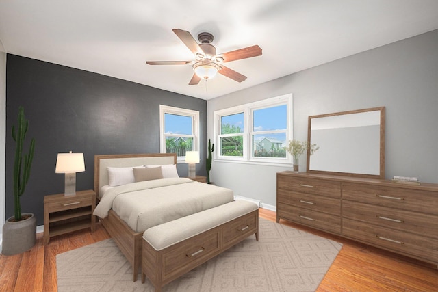 7432 Burlingame Ave SW, Byron Center, MI 49315 - bedroom featuring light wood-style floors, ceiling fan, and baseboards