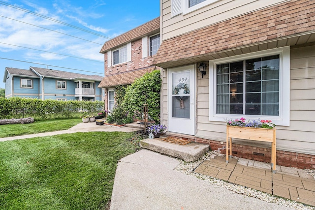 434 Riverbend Dr, Milan, MI 48160 - property entrance featuring a lawn and a shingled roof