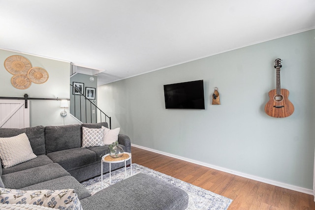 434 Riverbend Dr, Milan, MI 48160 - living room with baseboards, wood finished floors, stairs, and crown molding