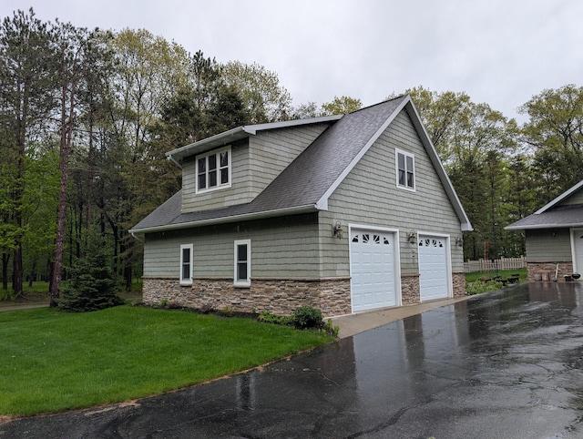 6919 Abrahamson Rd, Ludington, MI 49431 - view of side of property featuring stone siding, a lawn, and a shingled roof