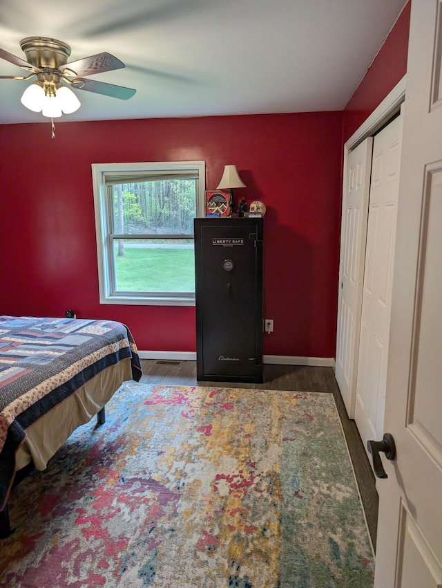 6919 Abrahamson Rd, Ludington, MI 49431 - bedroom with wood finished floors, baseboards, ceiling fan, and a closet