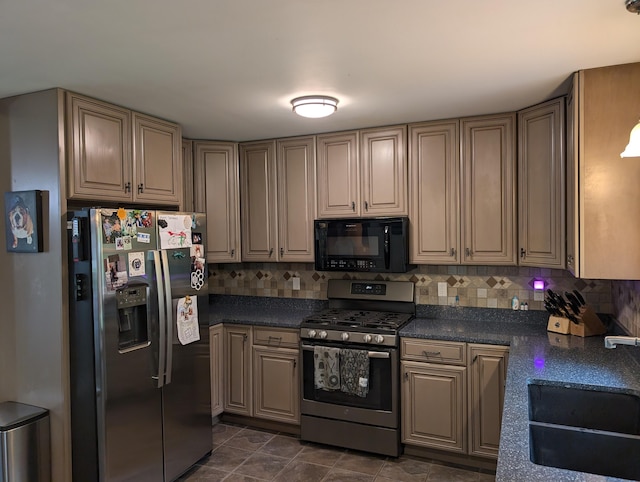 6919 Abrahamson Rd, Ludington, MI 49431 - kitchen with stainless steel appliances, a sink, dark countertops, and decorative backsplash