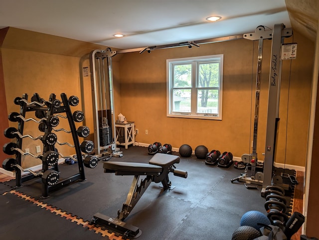 6919 Abrahamson Rd, Ludington, MI 49431 - exercise room featuring vaulted ceiling and recessed lighting