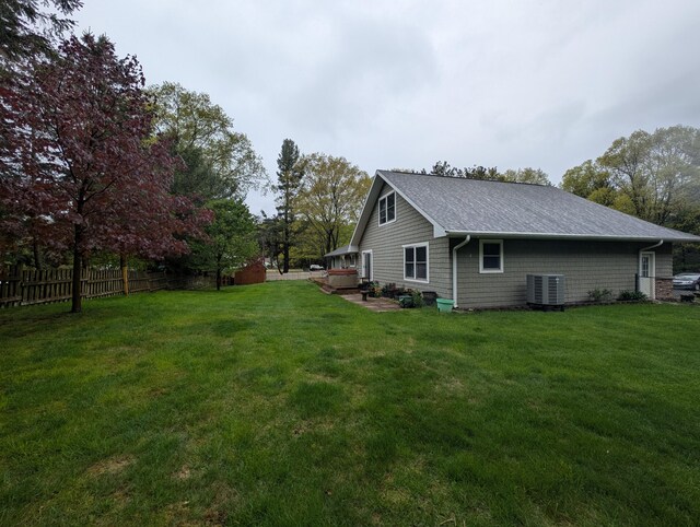 6919 Abrahamson Rd, Ludington, MI 49431 - view of side of home with central AC and a shingled roof