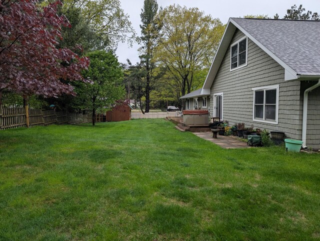 6919 Abrahamson Rd, Ludington, MI 49431 - view of yard featuring a hot tub and a patio