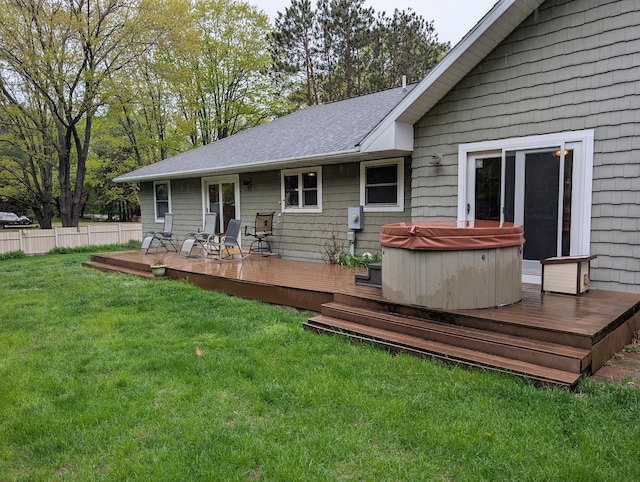 6919 Abrahamson Rd, Ludington, MI 49431 - back of property with a hot tub, a wooden deck, and a shingled roof
