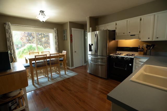 4314 Wilson Ave SW, Grandville, MI 49418 - kitchen featuring stainless steel fridge with ice dispenser, gas range, under cabinet range hood, and white cabinetry