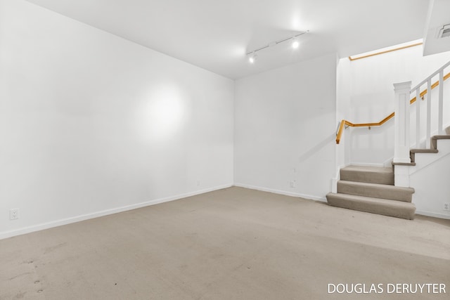 7470 Parmalee Rd, Middleville, MI 49333 - unfurnished room with rail lighting, stairs, baseboards, and carpet flooring