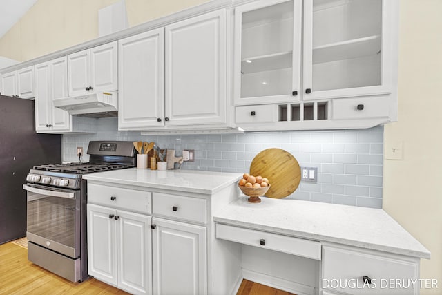 7470 Parmalee Rd, Middleville, MI 49333 - kitchen featuring gas stove, under cabinet range hood, white cabinets, tasteful backsplash, and glass insert cabinets