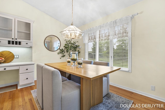 7470 Parmalee Rd, Middleville, MI 49333 - dining space with a chandelier, light wood finished floors, and baseboards