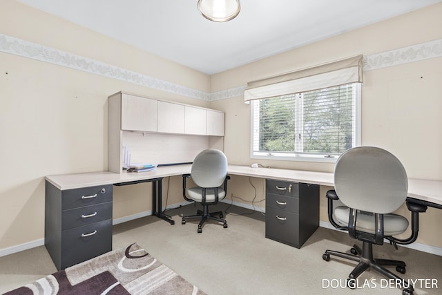 7470 Parmalee Rd, Middleville, MI 49333 - office area featuring baseboards, built in desk, and light colored carpet