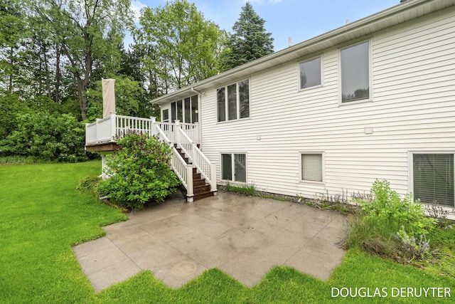 7470 Parmalee Rd, Middleville, MI 49333 - rear view of house with a patio, a lawn, stairs, and a wooden deck