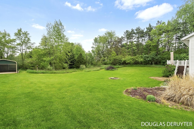 7470 Parmalee Rd, Middleville, MI 49333 - view of green lawn with a detached carport