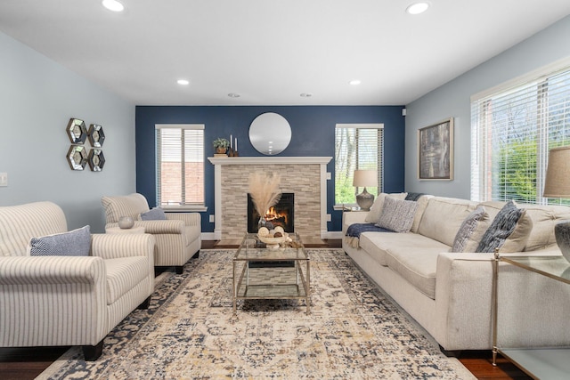 4139 Persimmon Dr, Ypsilanti, MI 48197 - living room featuring recessed lighting, wood finished floors, plenty of natural light, a lit fireplace, and baseboards