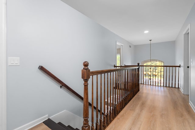4139 Persimmon Dr, Ypsilanti, MI 48197 - stairway featuring wood finished floors, baseboards, recessed lighting, and a chandelier