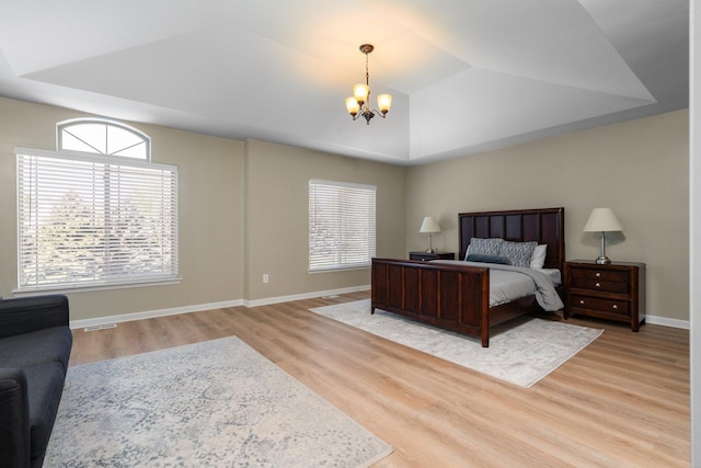 4139 Persimmon Dr, Ypsilanti, MI 48197 - bedroom featuring a chandelier, light wood finished floors, baseboards, and vaulted ceiling