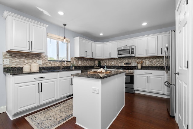 4139 Persimmon Dr, Ypsilanti, MI 48197 - kitchen featuring appliances with stainless steel finishes, white cabinets, dark wood-type flooring, decorative backsplash, and recessed lighting