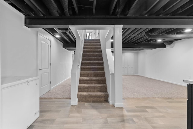 4139 Persimmon Dr, Ypsilanti, MI 48197 - finished below grade area featuring stairs, baseboards, light wood-style flooring, and light colored carpet