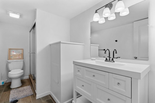 4139 Persimmon Dr, Ypsilanti, MI 48197 - bathroom with toilet, vanity, a shower with door, wood finished floors, and baseboards