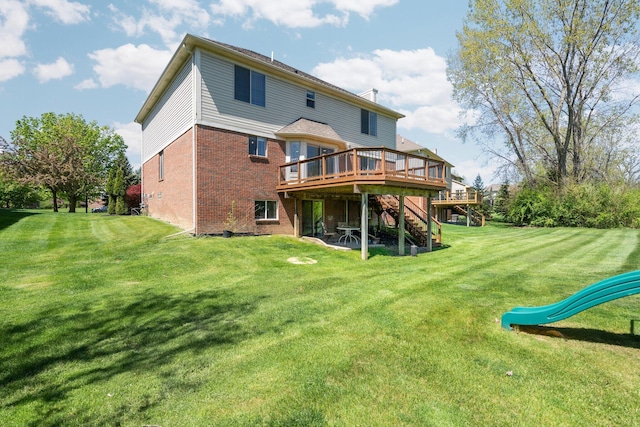 4139 Persimmon Dr, Ypsilanti, MI 48197 - back of property with a wooden deck, brick siding, stairs, and a lawn