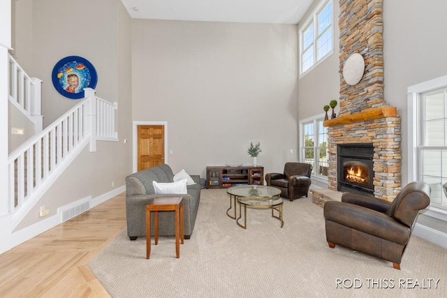 12644 60th Ave, Allendale, MI 49401 - living room featuring a high ceiling, stairs, a fireplace, and baseboards