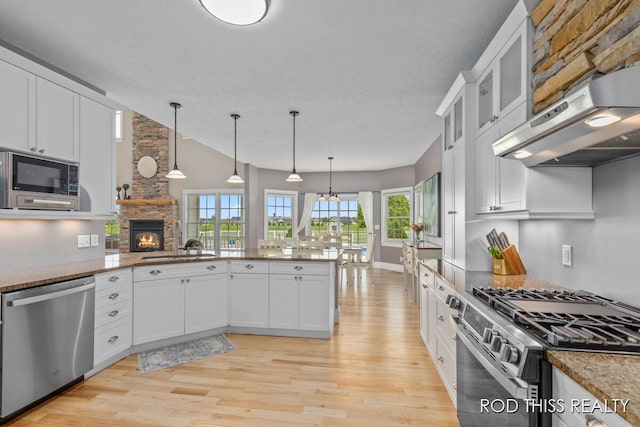 12644 60th Ave, Allendale, MI 49401 - kitchen with appliances with stainless steel finishes, light wood-style flooring, under cabinet range hood, and white cabinetry