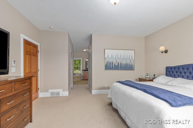 12644 60th Ave, Allendale, MI 49401 - bedroom featuring light carpet, baseboards, and ensuite bath