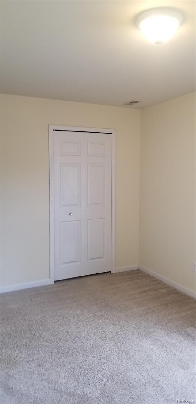 27615 Hidden Oaks Dr Unit 16, Trenton, MI 48183 - unfurnished bedroom featuring carpet, baseboards, and a closet