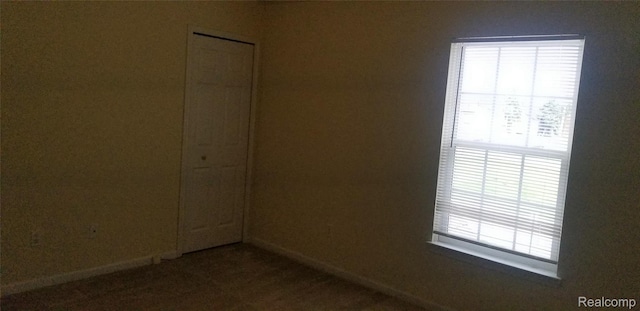 27615 Hidden Oaks Dr Unit 16, Trenton, MI 48183 - empty room with baseboards and carpet flooring