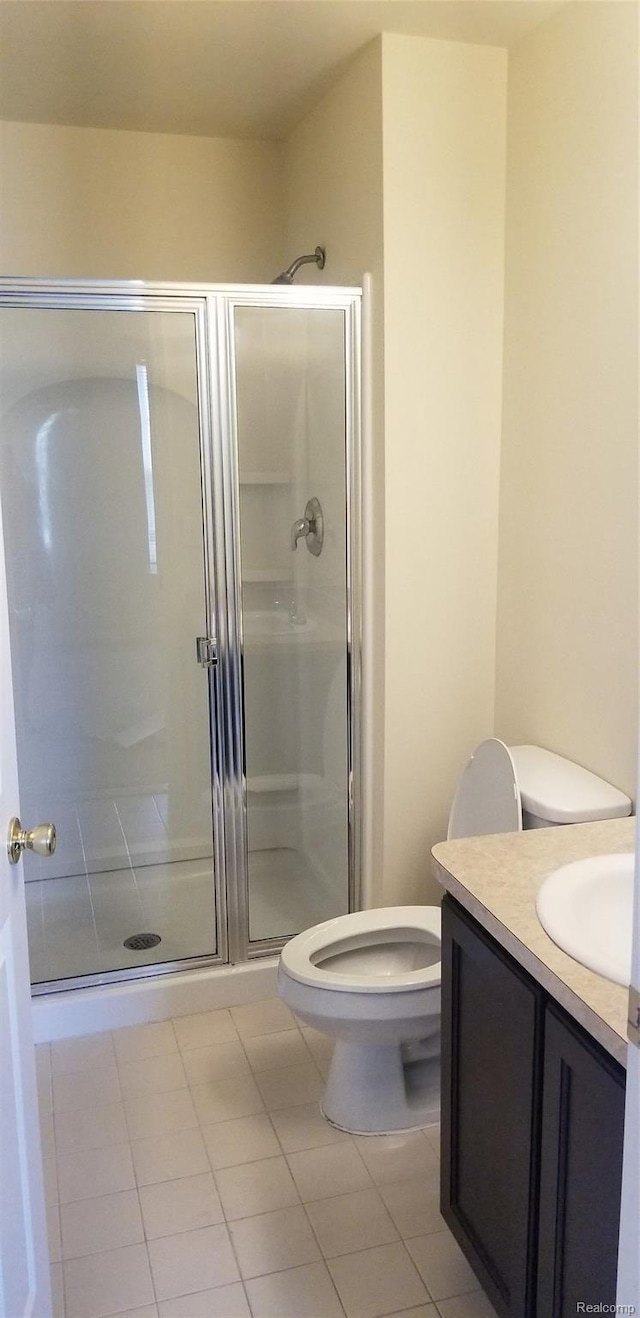 27615 Hidden Oaks Dr Unit 16, Trenton, MI 48183 - bathroom featuring vanity, toilet, a stall shower, and tile patterned flooring