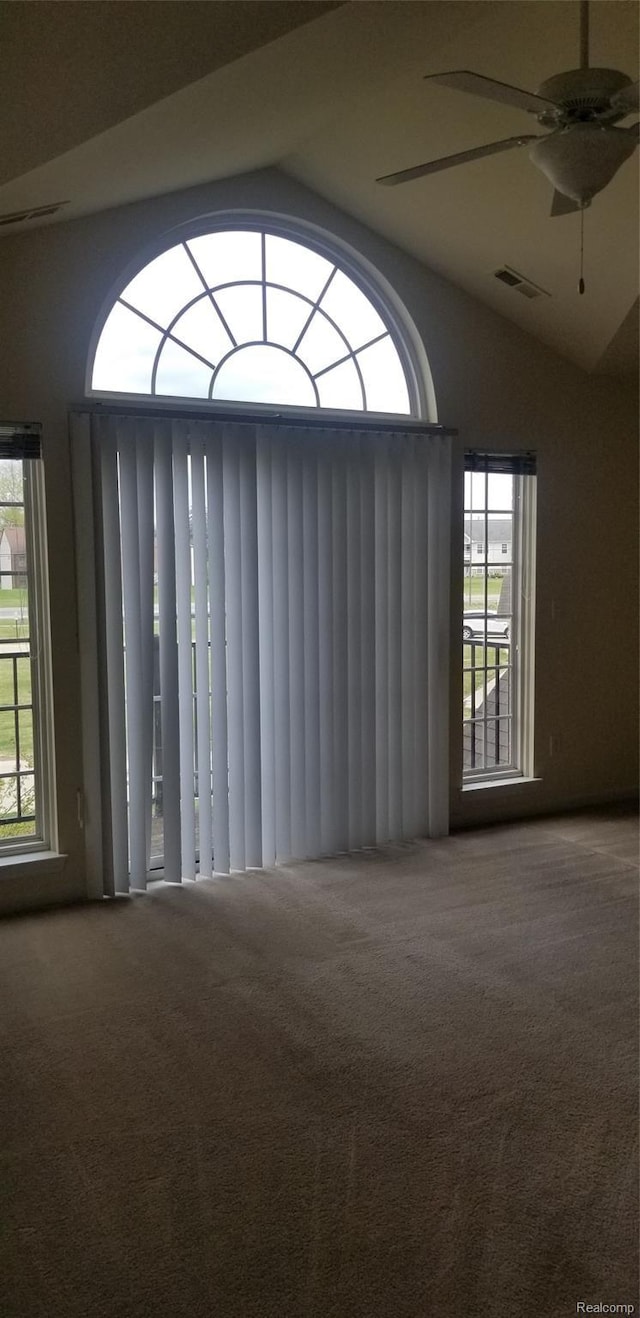 27615 Hidden Oaks Dr Unit 16, Trenton, MI 48183 - carpeted empty room featuring healthy amount of natural light, vaulted ceiling, and ceiling fan