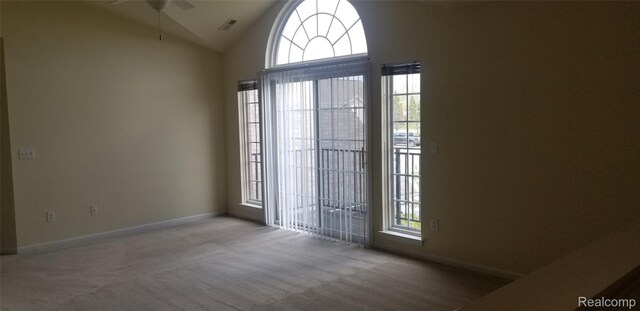 27615 Hidden Oaks Dr Unit 16, Trenton, MI 48183 - empty room with a ceiling fan, carpet, plenty of natural light, lofted ceiling, and baseboards