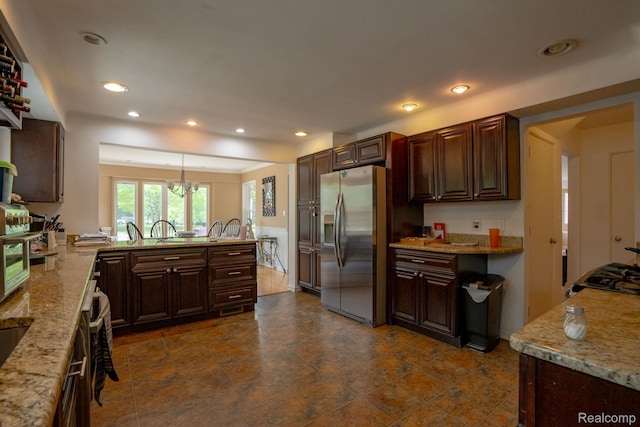 622 Sunningdale Dr, Grosse Pointe Woods, MI 48236 - kitchen with stainless steel fridge, a peninsula, recessed lighting, light stone counters, and decorative light fixtures