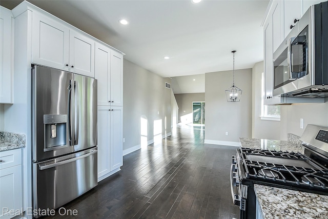 527 Indian Oaks Dr, Howell, MI 48843 - kitchen with stainless steel appliances, dark wood-style flooring, baseboards, white cabinetry, and light stone countertops