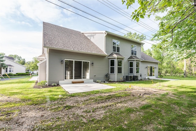 527 Indian Oaks Dr, Howell, MI 48843 - rear view of property with a patio area, a yard, and a shingled roof