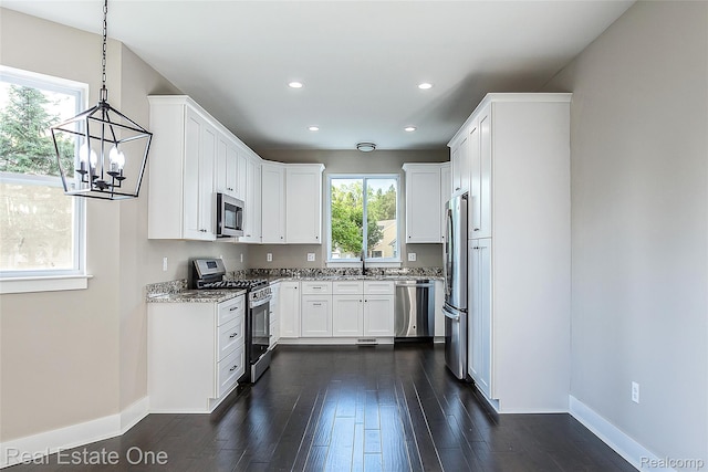 527 Indian Oaks Dr, Howell, MI 48843 - kitchen featuring appliances with stainless steel finishes, baseboards, a sink, dark wood-style floors, and recessed lighting