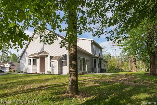 527 Indian Oaks Dr, Howell, MI 48843 - view of front of house with a front lawn and central AC unit