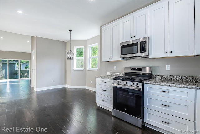 527 Indian Oaks Dr, Howell, MI 48843 - kitchen with stainless steel appliances, baseboards, light stone countertops, white cabinets, and recessed lighting