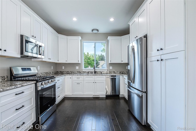 527 Indian Oaks Dr, Howell, MI 48843 - kitchen featuring appliances with stainless steel finishes, a sink, light stone countertops, white cabinets, and recessed lighting