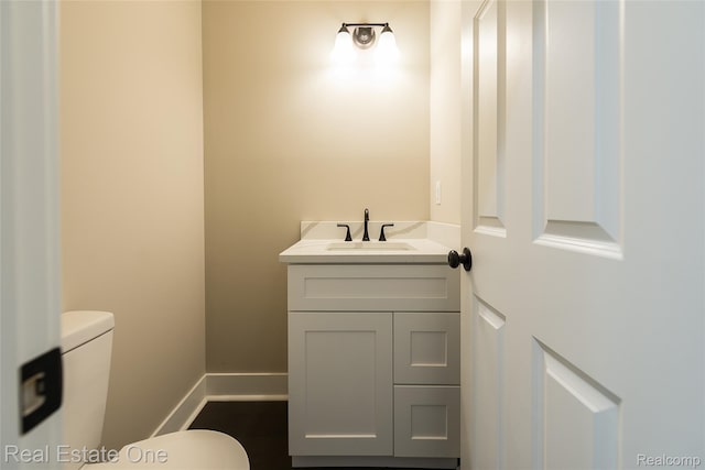 527 Indian Oaks Dr, Howell, MI 48843 - half bathroom featuring toilet, baseboards, and vanity