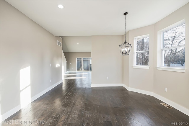527 Indian Oaks Dr, Howell, MI 48843 - unfurnished dining area with hardwood / wood-style floors, a chandelier, baseboards, and recessed lighting