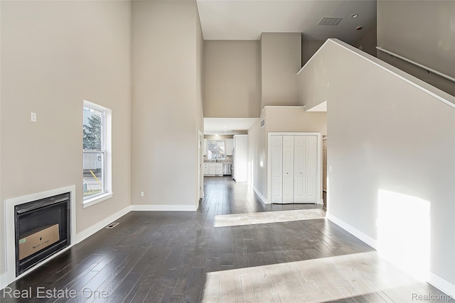 527 Indian Oaks Dr, Howell, MI 48843 - entryway featuring wood-type flooring, a high ceiling, baseboards, and a fireplace