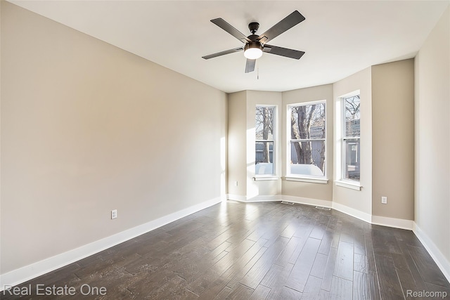 527 Indian Oaks Dr, Howell, MI 48843 - empty room featuring ceiling fan, dark wood-type flooring, and baseboards