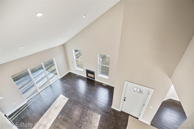 527 Indian Oaks Dr, Howell, MI 48843 - unfurnished living room featuring high vaulted ceiling, dark wood finished floors, baseboards, and recessed lighting