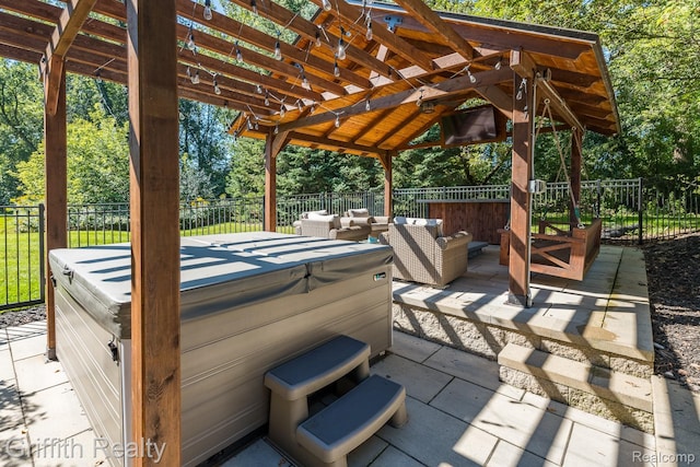 1804 Morgan Lake Ct, Brighton, MI 48114 - view of patio / terrace featuring a hot tub, an outdoor living space, view of scattered trees, and a gazebo