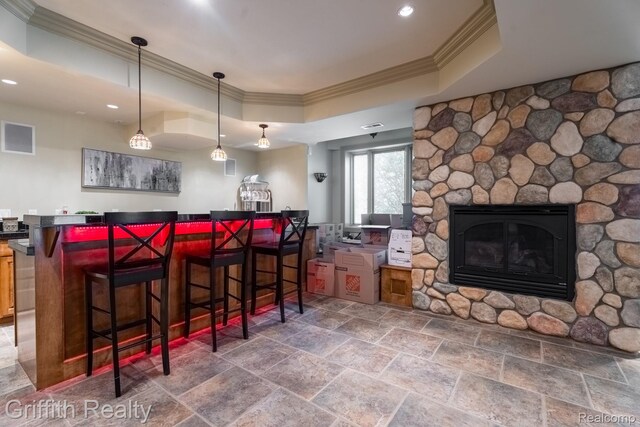 1804 Morgan Lake Ct, Brighton, MI 48114 - indoor dry bar with crown molding, a raised ceiling, stone tile flooring, a fireplace, and recessed lighting