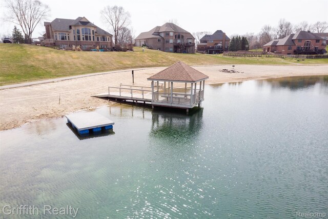 1804 Morgan Lake Ct, Brighton, MI 48114 - dock area with a gazebo, a water view, a lawn, and a residential view