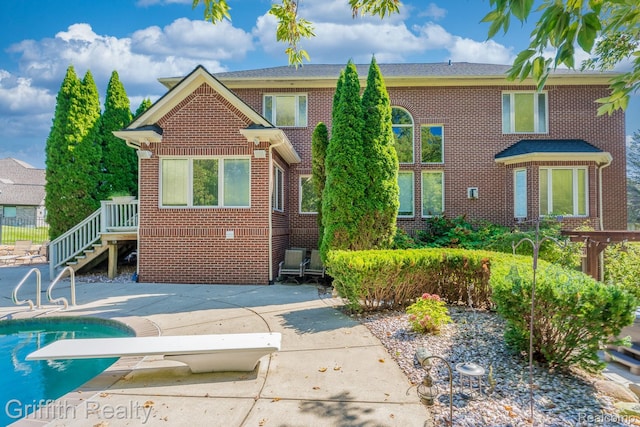 1804 Morgan Lake Ct, Brighton, MI 48114 - view of front facade featuring brick siding, an outdoor pool, and a patio area