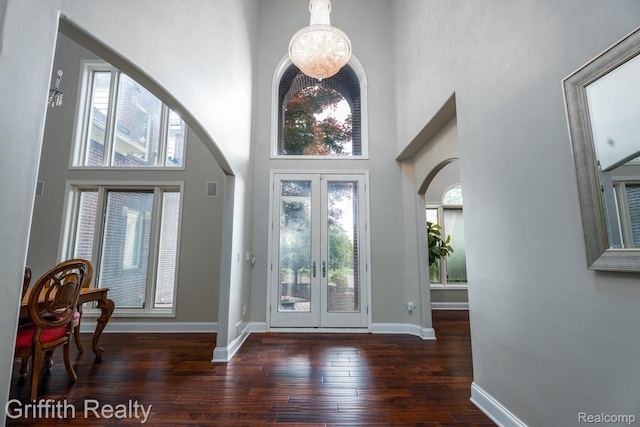 1804 Morgan Lake Ct, Brighton, MI 48114 - foyer entrance with arched walkways, a towering ceiling, wood-type flooring, french doors, and baseboards